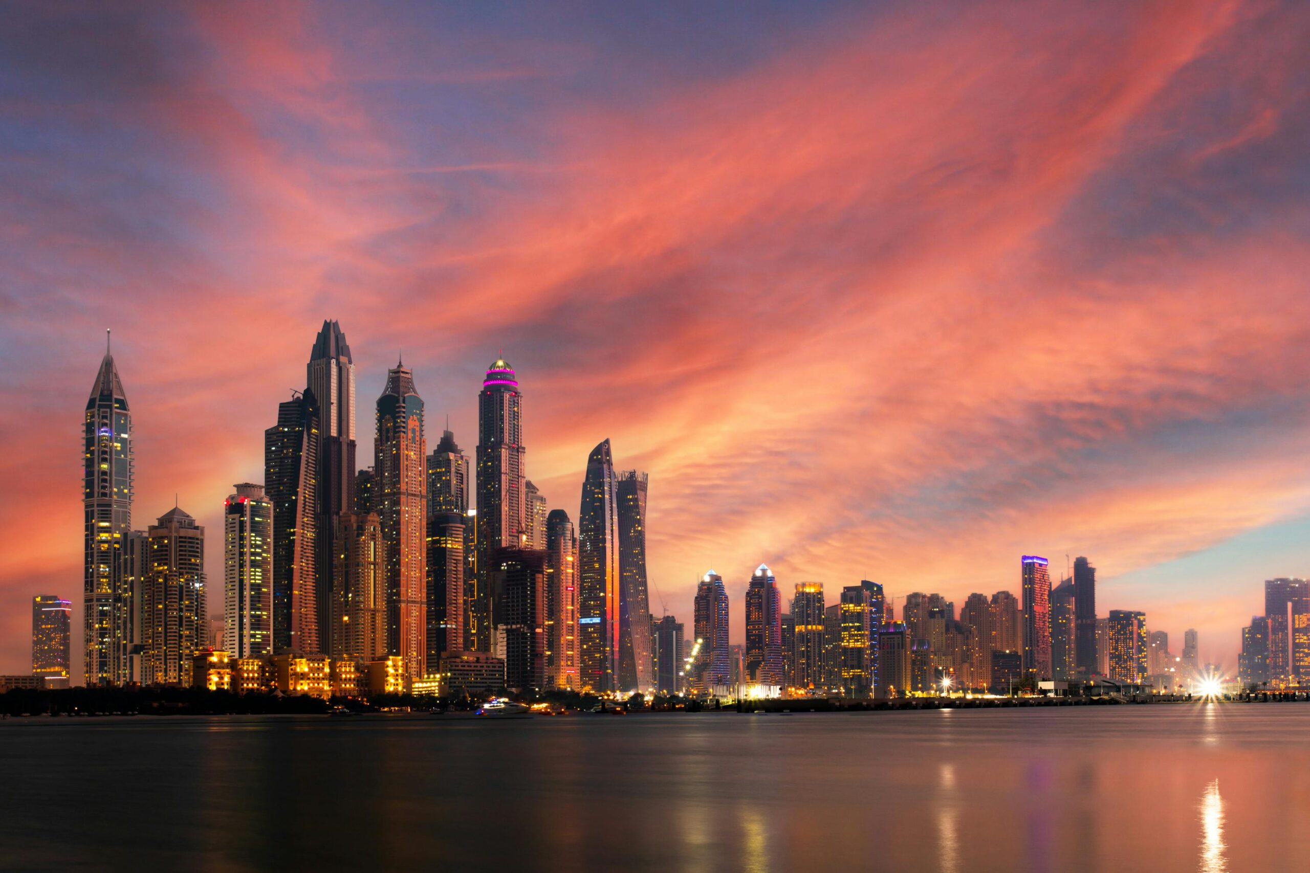 "A stunning view of Dubai’s skyline, featuring the towering Burj Khalifa, modern skyscrapers, and the city’s vibrant lights at night."