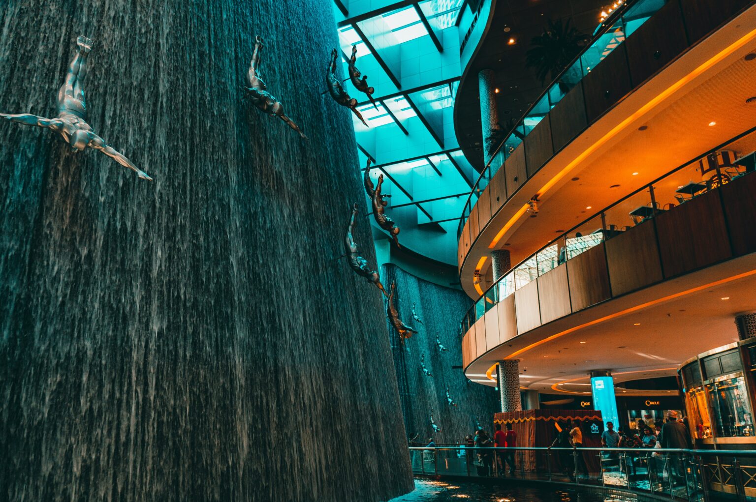 A striking photo of gravity-defying, upside-down sculptures hanging from the ceiling in Dubai Mall, showcasing intricate details and modern artistry