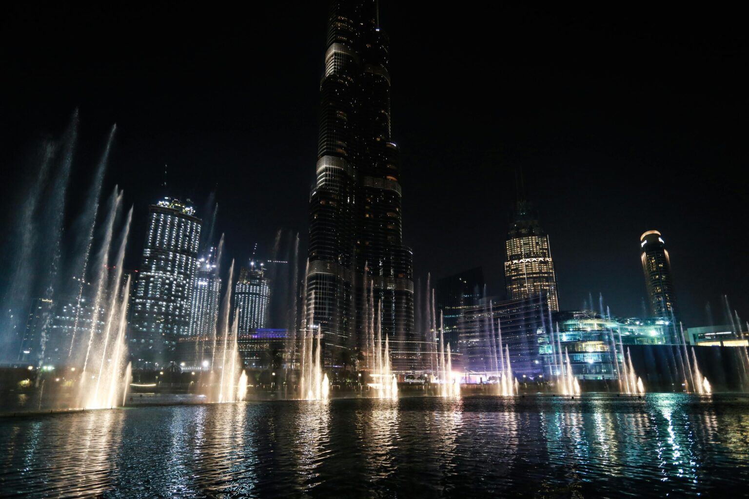 The Dubai Fountain dancing with Burj Khalifa in the background - A breathtaking scene combining art and architecture