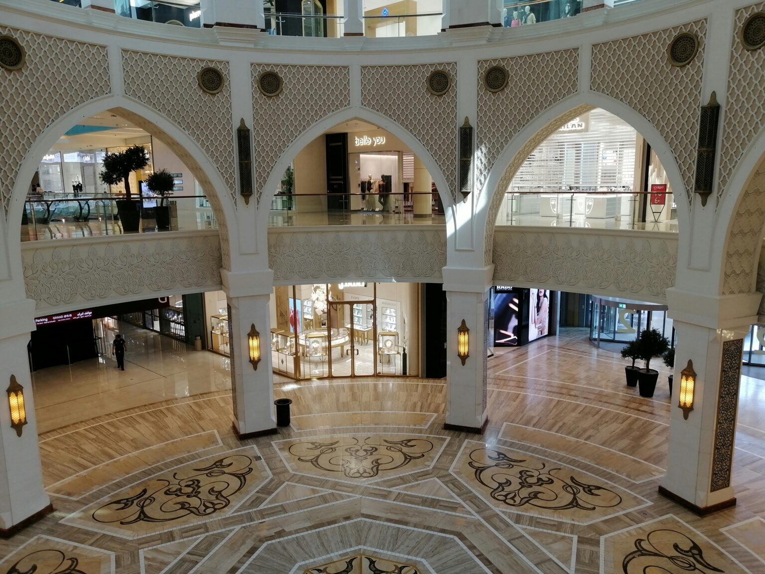 A wide-angle shot of Dubai Mall's stunning interior, featuring high ceilings, elegant design elements, and bustling visitors enjoying the luxurious shopping experience.